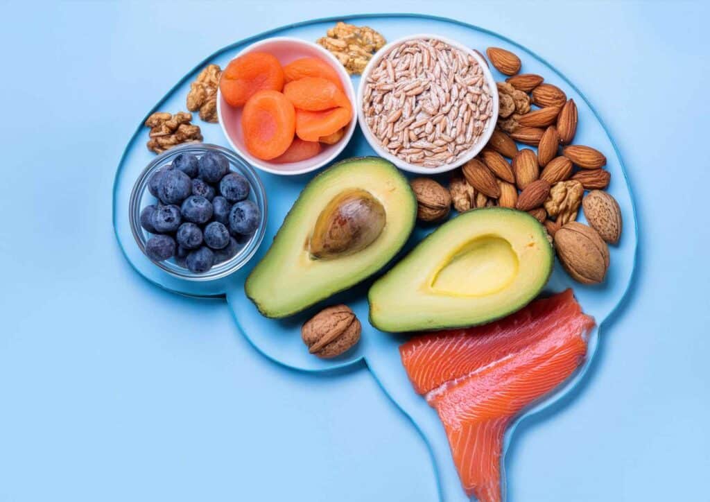 Best Foods for Brain Health 9 A plate shaped like a brain filled with various colourful foods, symbolising healthy eating for brain health.