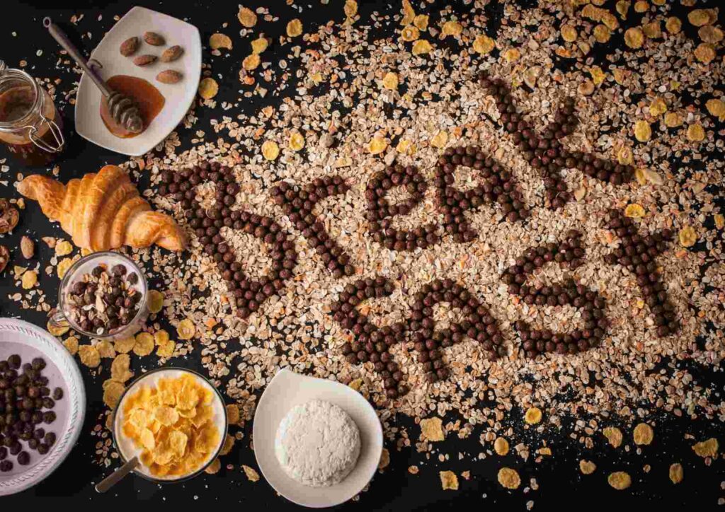 Is Breakfast the Most Important Meal of the Day? 5 A colorful spread of healthy breakfast foods including fruits, whole grains, and yoghurt on a wooden table.