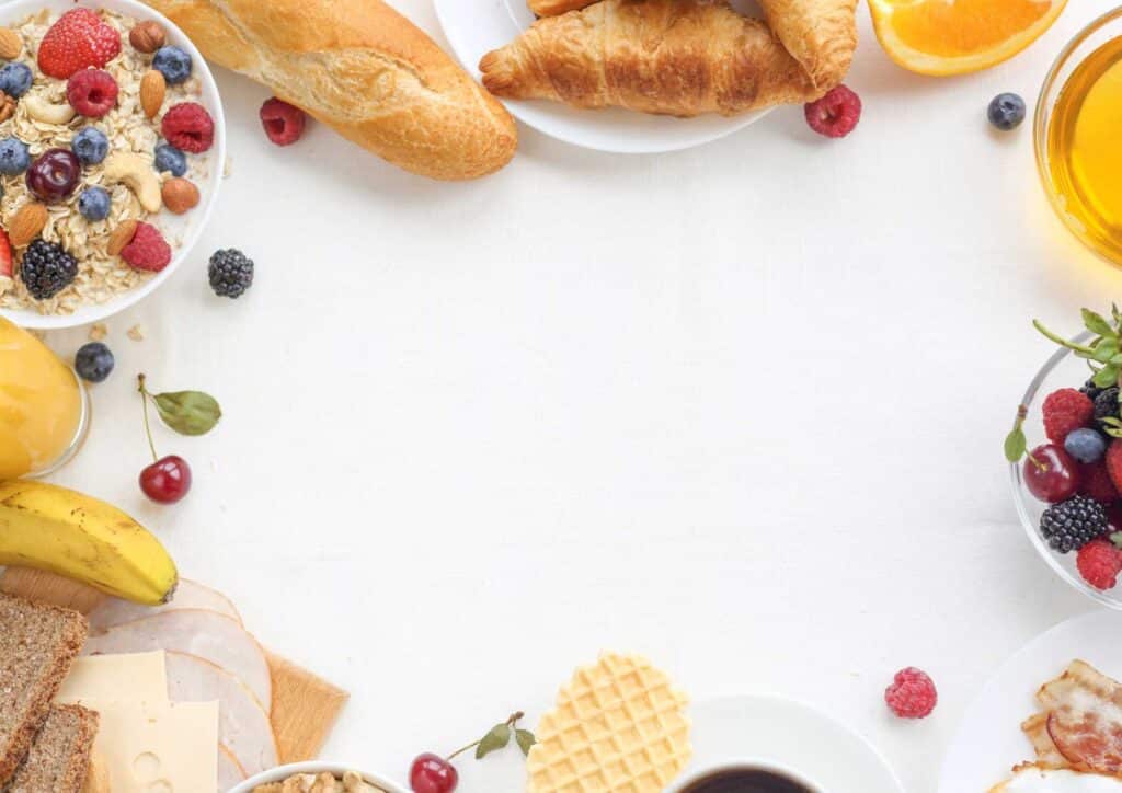 Is Breakfast the Most Important Meal of the Day? 9 A variety of breakfast foods, including eggs, toast, and fruit, beautifully arranged on a white table.
