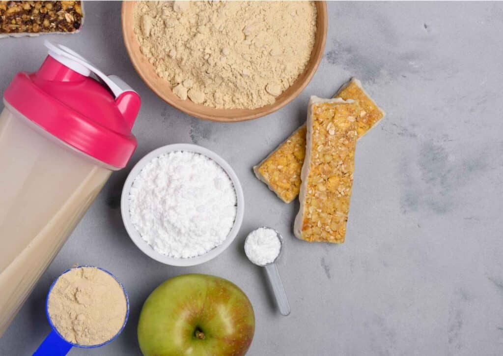 What Is A Sports Nutritionist? 10 A collection of protein shake ingredients including protein powder, milk, banana, and a scoop for mixing.