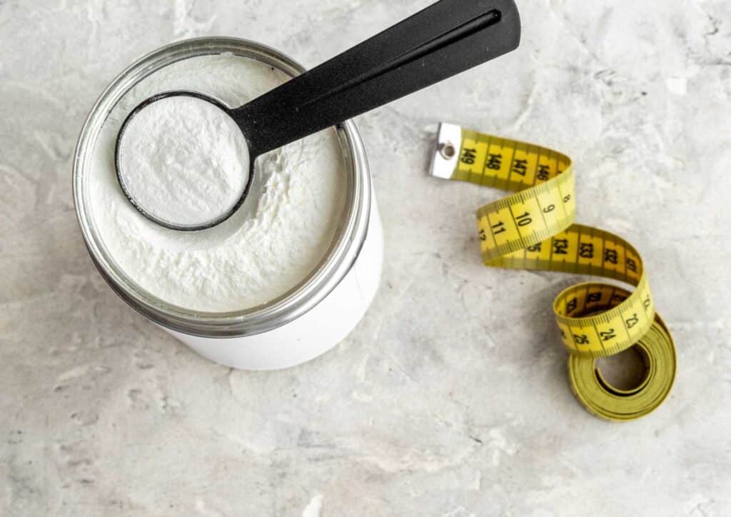 What Is A Sports Nutritionist? 9 A person standing on a scale, measuring their weight loss progress in a bright, well-lit room.