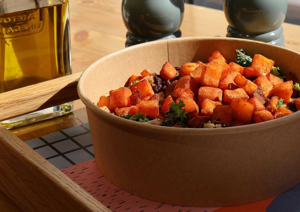 Is Sweet Potato Good for Weight Loss? 10 A bowl of colourful food placed on a wooden table, showcasing a variety of ingredients.