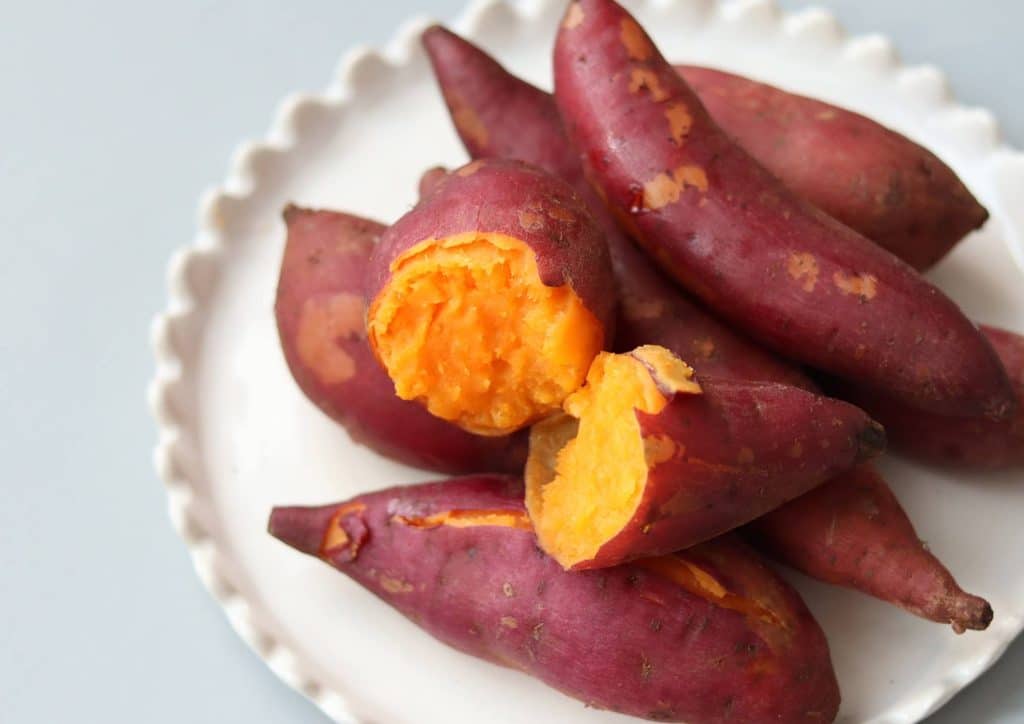 Is Sweet Potato Good for Weight Loss? 27 Chopped sweet potatoes arranged on a white plate, showcasing their vibrant orange colour and smooth texture.