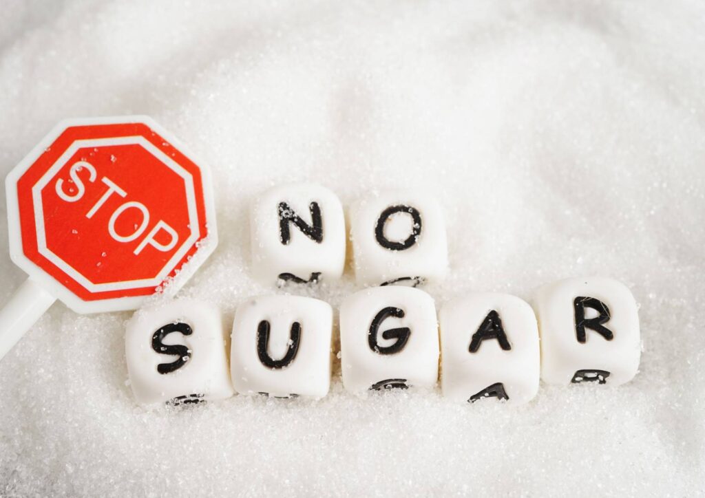 Are Grapes Good for Weight Loss? 2 A white background with a dice cubes with the words no sugar in capital letters and a stop sign.