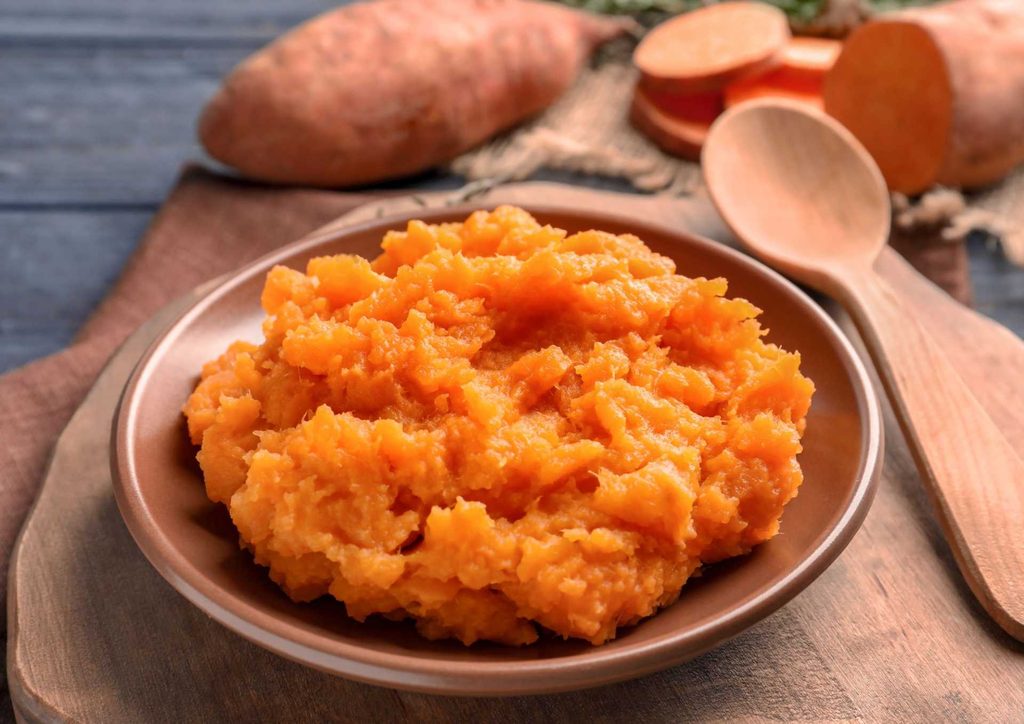 Is Sweet Potato Good for Weight Loss? 14 A close-up of sweet potatoes, highlighting their vibrant orange color, emphasising their high vitamin C content.