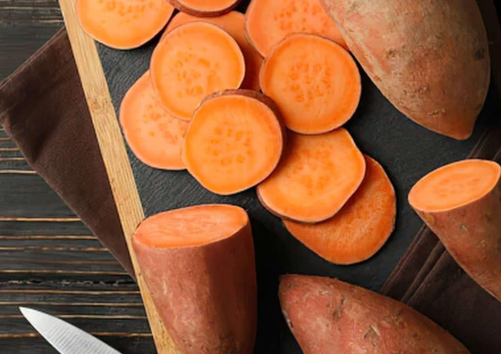 Is Sweet Potato Good for Weight Loss? 13 Sliced sweet potatoes arranged on a plate, ready for consumption.