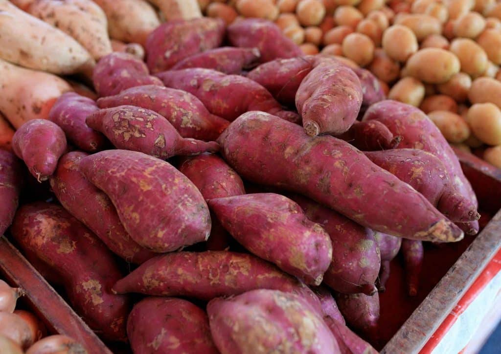 Is Sweet Potato Good for Weight Loss? 18 A box containing an assortment of sweet potatoes and regular potatoes, showcasing their different shapes and colours.