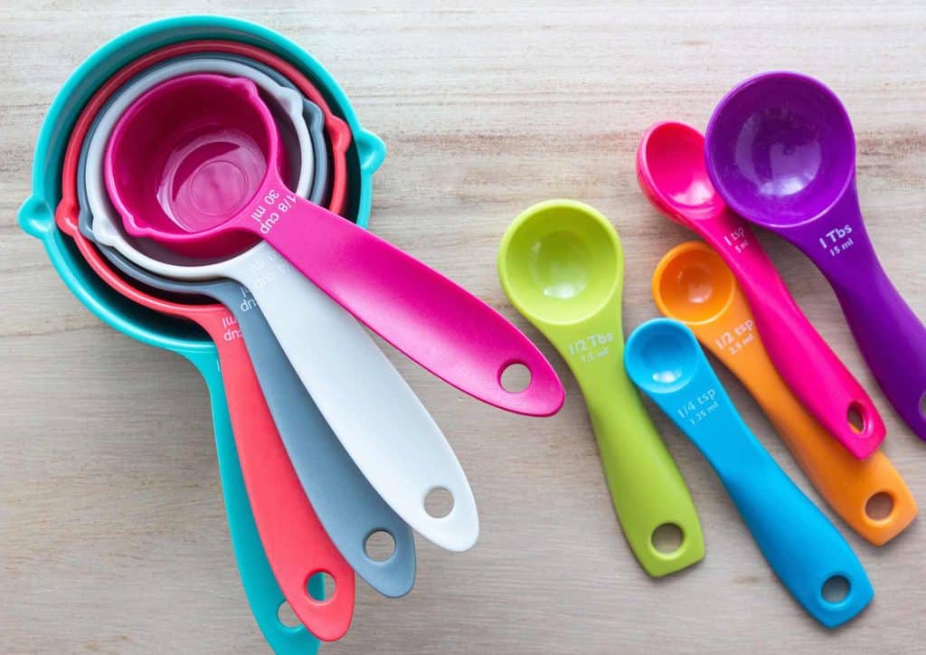 Do Chia Seeds Help With Weight Loss? 9 A set of colourful measuring spoons and cups arranged together, showcasing various sizes and vibrant hues.