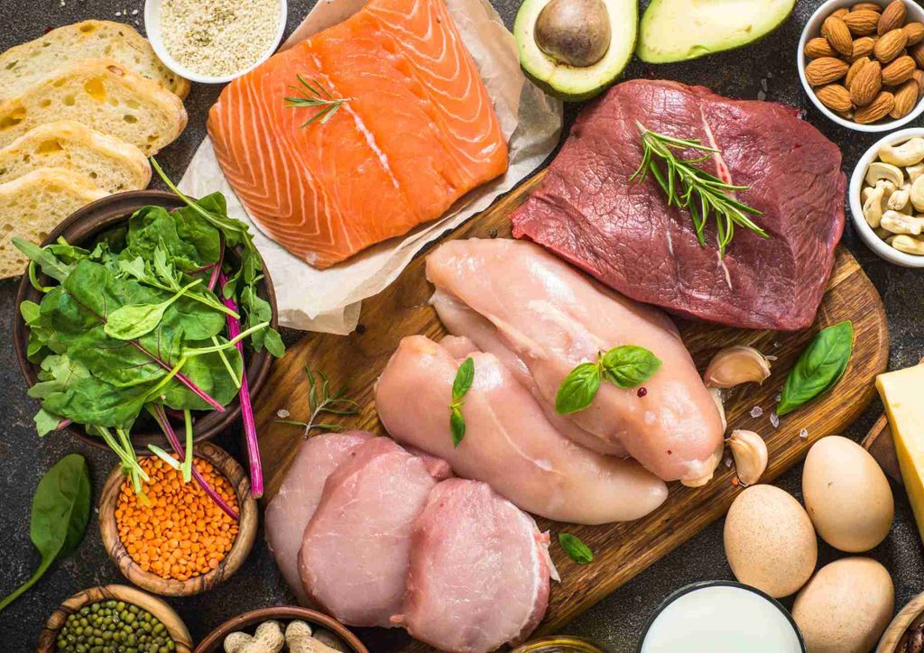 High-Protein Foods for Weight Loss 8 A variety of heart-healthy foods including fruits, vegetables, nuts, and whole grains displayed on a wooden table.