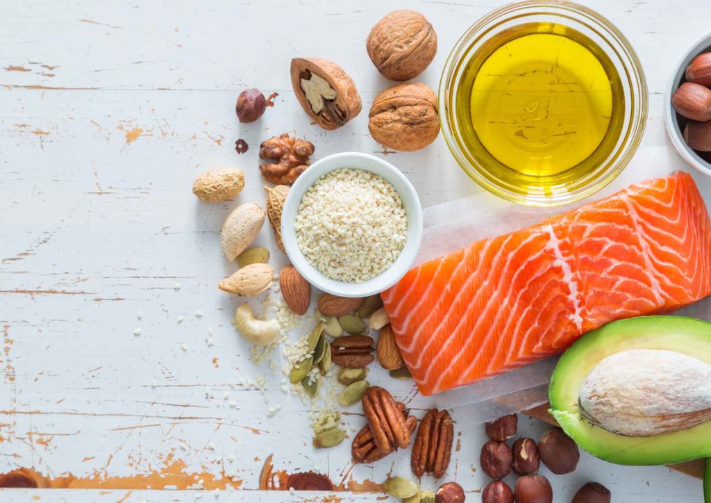 High-Protein Foods for Weight Loss 16 A variety of heart-healthy foods including fruits, vegetables, nuts, and whole grains displayed on a wooden table.