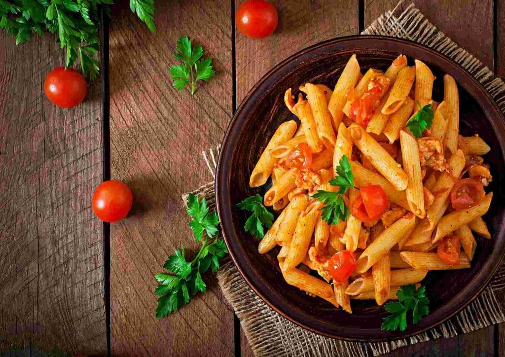 Is Pasta Good for Weight Loss? 26 Penne pasta served with a rich tomato sauce, garnished with fresh basil leaves.