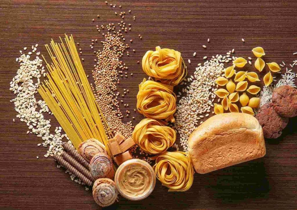 Is Pasta Good for Weight Loss? 14 A variety of high-fibre foods including beans, whole grains, fruits, and vegetables displayed on a wooden table.