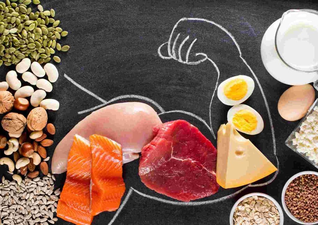 High-Protein Foods for Weight Loss 11 A variety of foods including chicken, eggs, quinoa, and spinach, arranged on a wooden table, promoting muscle growth.