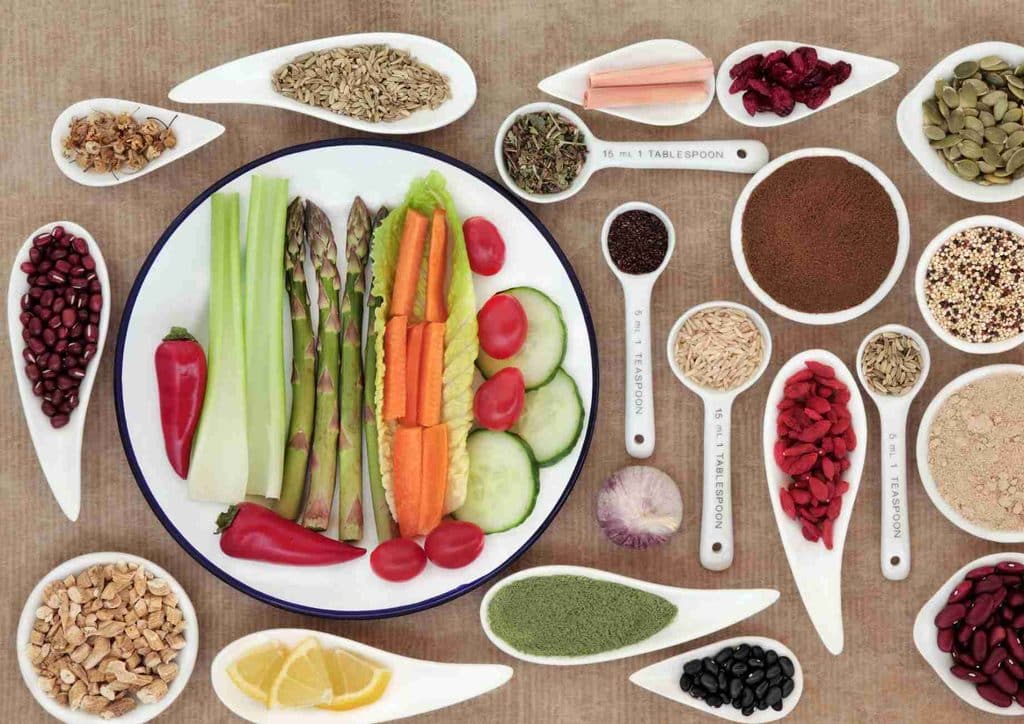 The Best Foods for Weight Loss 28 An assortment of healthy foods, including fruits, vegetables, and grains, displayed in colourful bowls on a wooden surface.