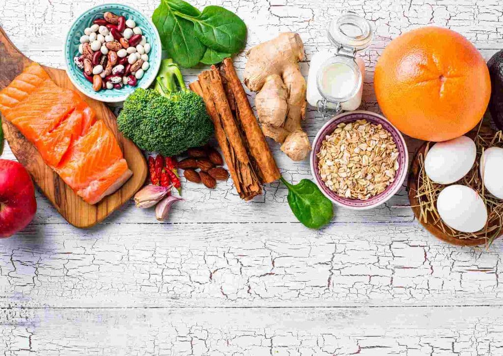 The Best Foods for Weight Loss 31 A variety of heart-healthy foods including fruits, vegetables, nuts, and whole grains displayed on a wooden table.
