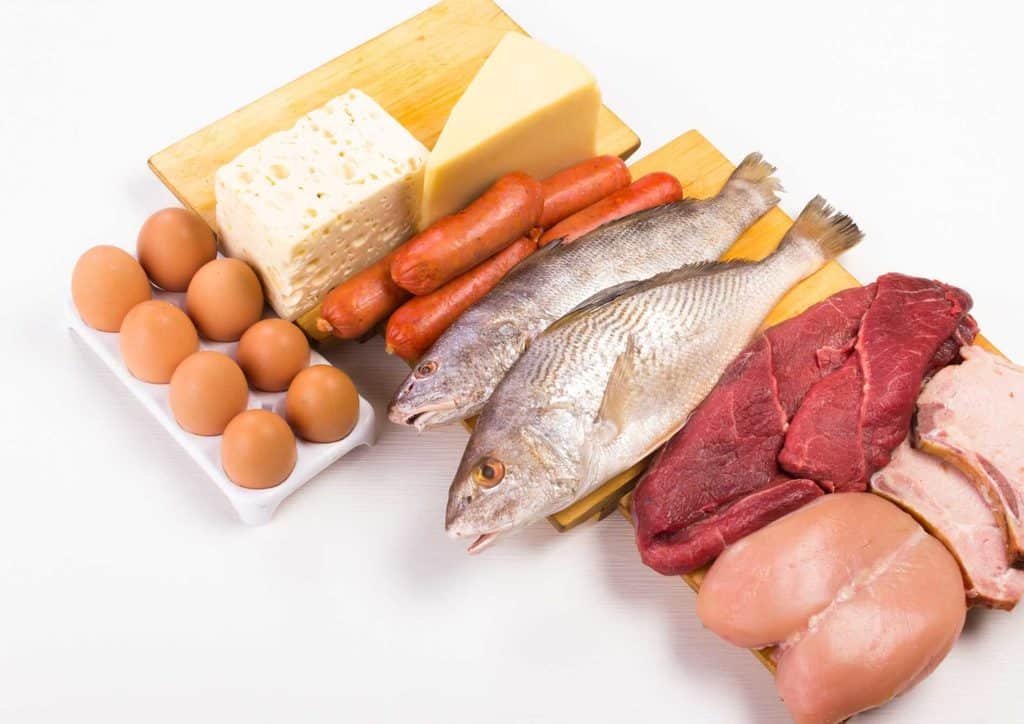 High-Protein Foods for Weight Loss 17 A cutting board displays an assortment of meats, eggs, fish, and cheese arranged for preparation or serving.