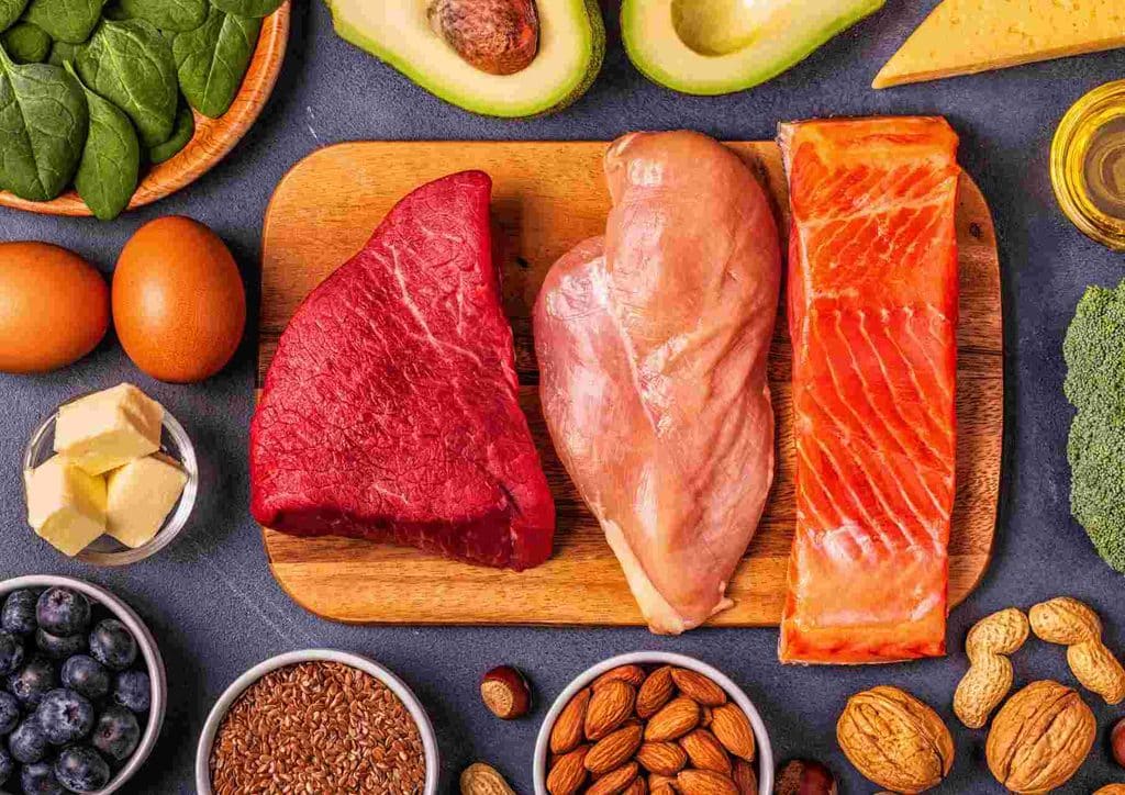High-Protein Foods for Weight Loss 7 A variety of heart-healthy foods including fruits, vegetables, nuts, and whole grains displayed on a wooden table.