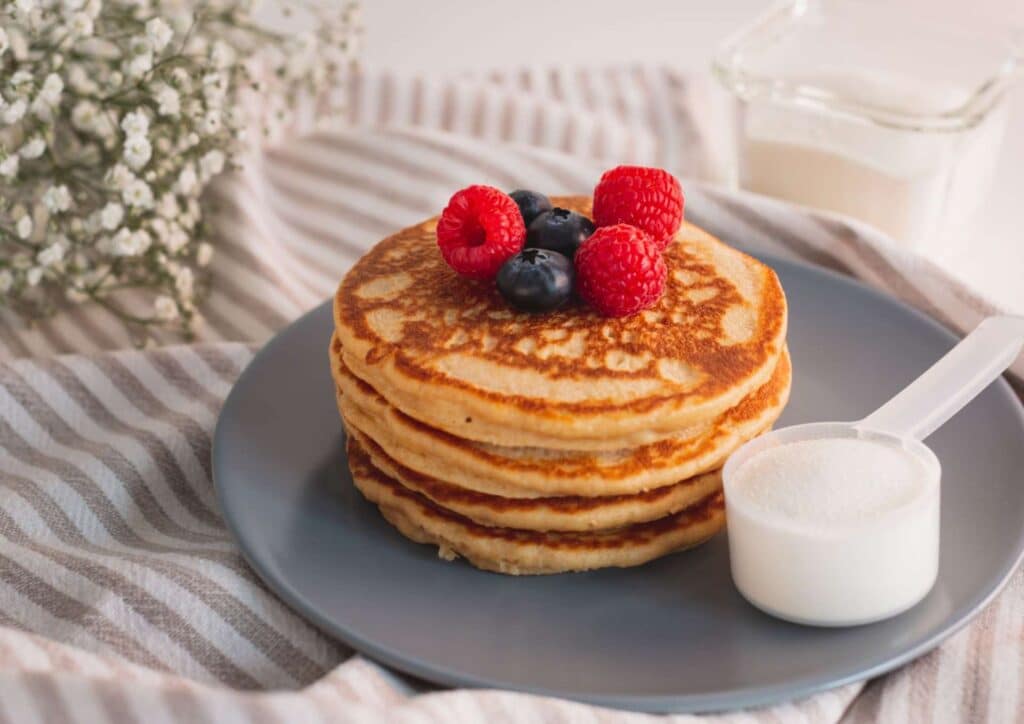 Protein Pancakes Breakfast Recipe for Weight Loss 5 A plate of pancakes topped with fresh berries, showcasing a delicious breakfast option.