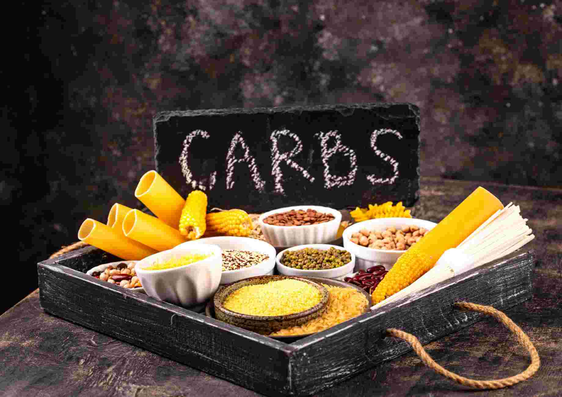 Nutrition Longevity With Jake Biggs 8 A tray displaying various food items labeled with a sign reading "carbs".