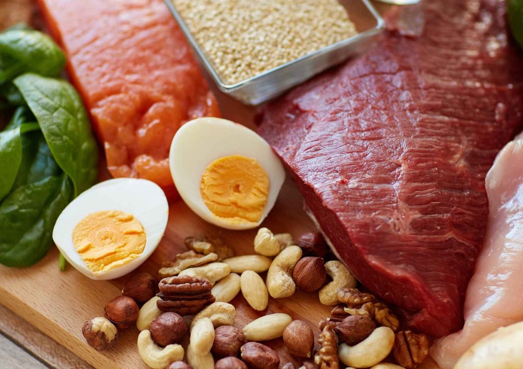 Why Am I Not Losing Weight? 8 Reasons a Nutritionist Sees Every Week 11 A colourful assortment of heart-healthy foods including fruits, vegetables, nuts, and whole grains on a wooden table.