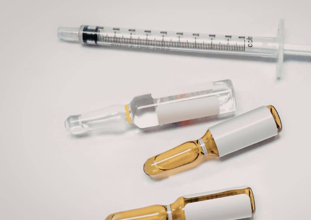 Natural Alternatives to Ozempic for Weight Loss 24 A syringe next to a vial and a vial with a white cap, indicating medical supplies for injection or medication preparation.