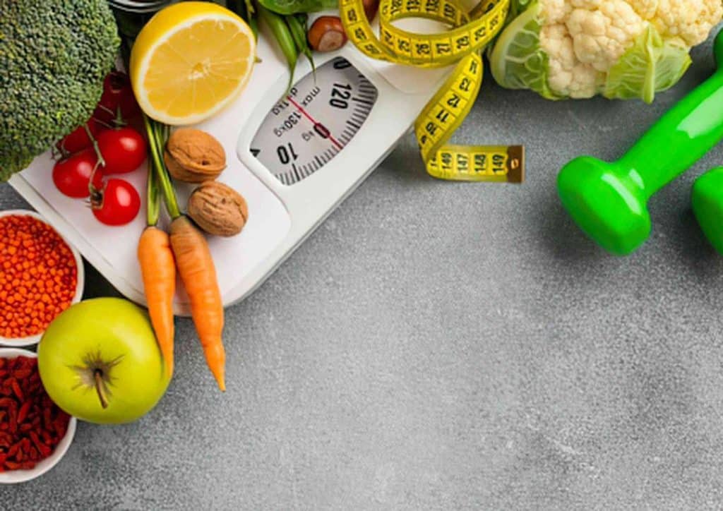 How to Lose Weight Without Exercise 18 A scale holding multiple fruits and vegetables, illustrating a colourful selection of produce ready for weighing.