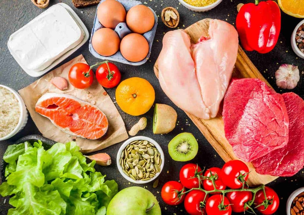 Natural Alternatives to Ozempic for Weight Loss 12 A variety of heart-healthy foods including fruits, vegetables, nuts, and whole grains displayed on a wooden table.