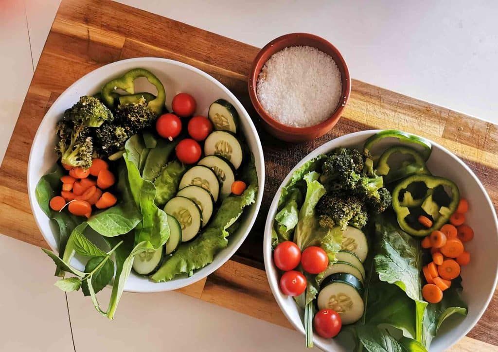 Natural Alternatives to Ozempic for Weight Loss 14 Two bowls filled with assorted vegetables placed on a wooden cutting board.