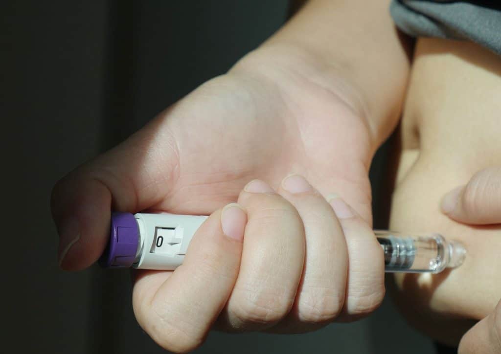 Natural Alternatives to Ozempic for Weight Loss 6 A person holding a digital thermometer in their right hand, checking the temperature reading.