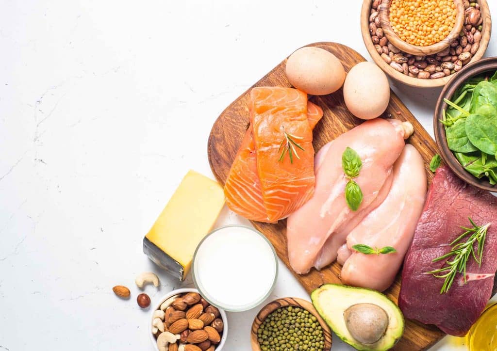 How to Speed Up Your Metabolism (What Actually Works) 13 A variety of heart-healthy foods including fruits, vegetables, nuts, and whole grains displayed on a wooden table.
