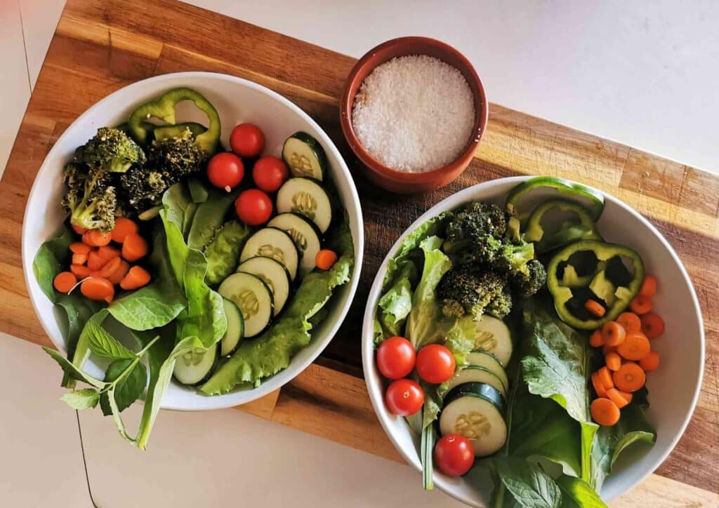 Losing Weight While Breastfeeding: What's Safe and Realistic 10 Two bowls filled with assorted fresh vegetables placed on a wooden cutting board.