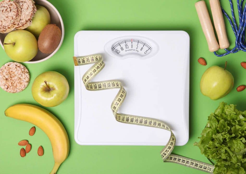 What Is a Balanced Diet for Weight Loss? 7 An array of healthy foods, featuring vegetables, fruits, and nuts, illustrating a balanced approach to weight loss and wellness.