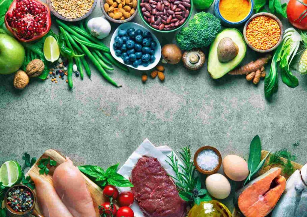What Is a Balanced Diet for Weight Loss? 4 A diverse spread of food items including various meats, fresh fish, vibrant vegetables, and ripe fruits on display.