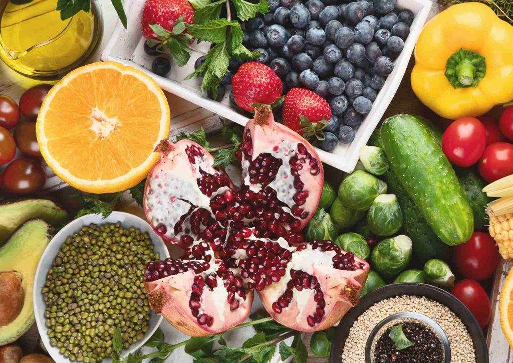 High Fibre Diet for Weight Loss: Why Fibre Keeps You Full 53 Bowls filled with an array of fresh fruits and vegetables, highlighting their vibrant colours and diverse textures.