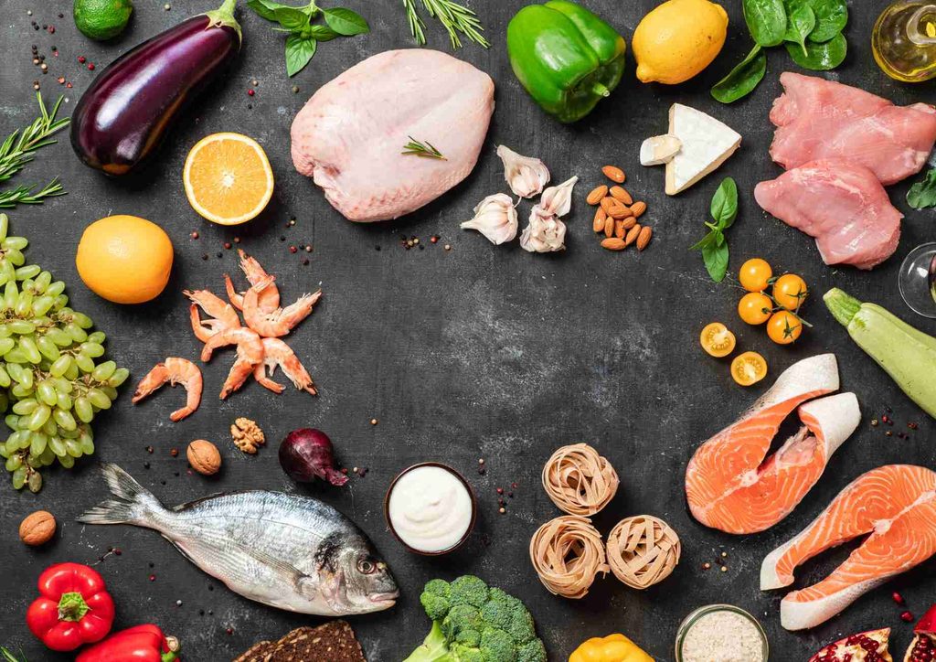 Is the Mediterranean Diet Good for Weight Loss? 14 A circular arrangement of diverse food items, showcasing fruits, vegetables, and snacks in an appealing display.