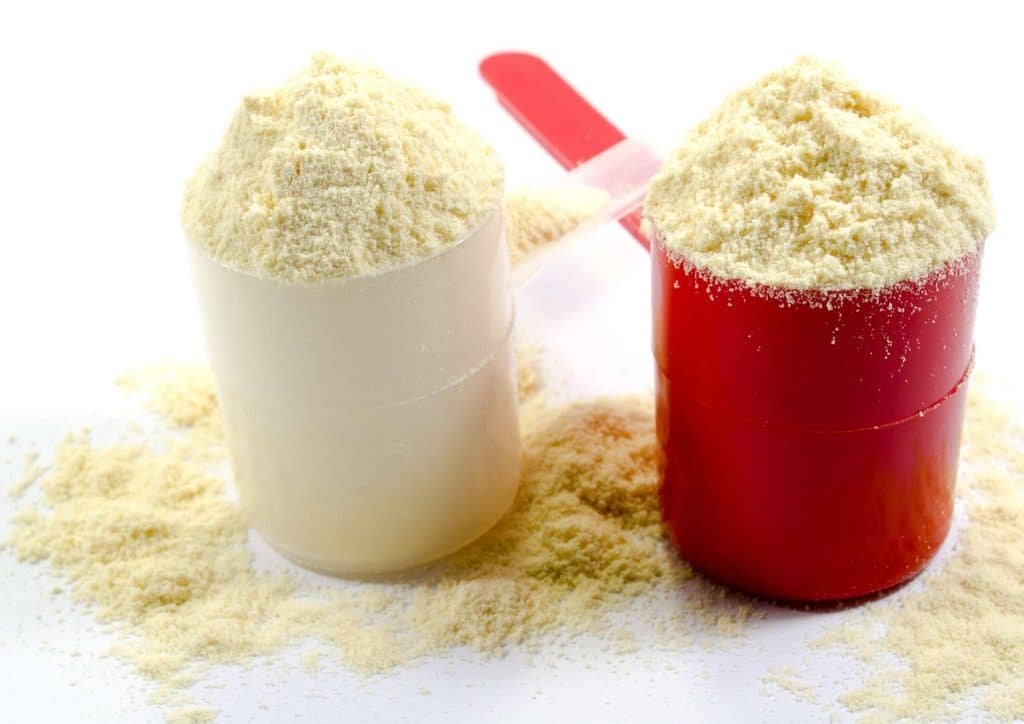 Is Whey Protein Good for Weight Loss? 53 Two containers of powder with a spoon resting beside them on a flat surface.