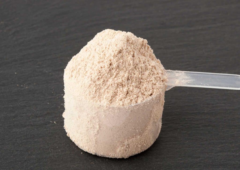 Is Whey Protein Good for Weight Loss? 51 A spoonful of powder resting on a scoop, showcasing the texture and colour of the substance.
