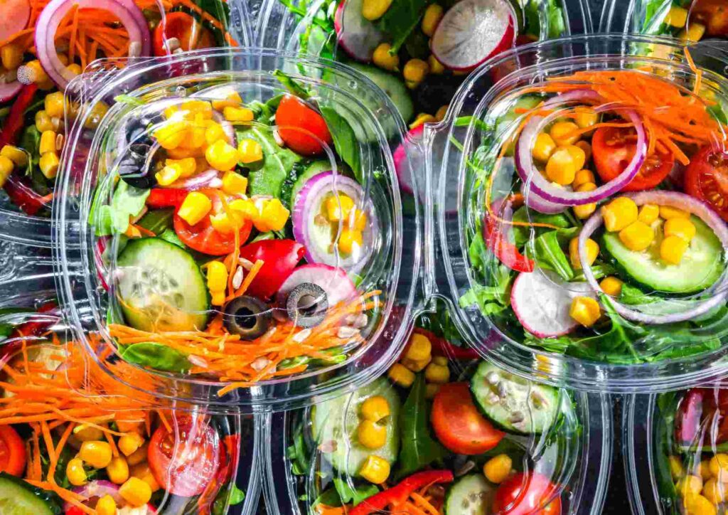 Easy Meals for Weight Loss When You're Short on Time 13 A collection of plastic containers filled with various types of salad, arranged neatly on a table.