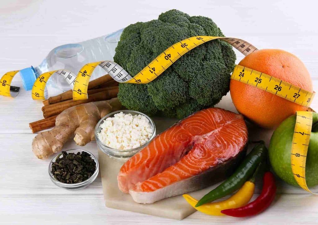 Losing Weight While Breastfeeding: What's Safe and Realistic 33 A diverse spread of food items including fish, assorted vegetables, and various spices arranged on a rustic table.