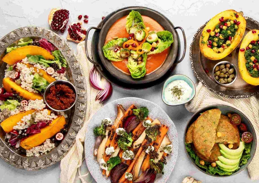 Vegetarian Diet for Weight Loss: How to Get It Right 17 An assortment of dishes featuring various types of food arranged on plates, showcasing diverse culinary styles.