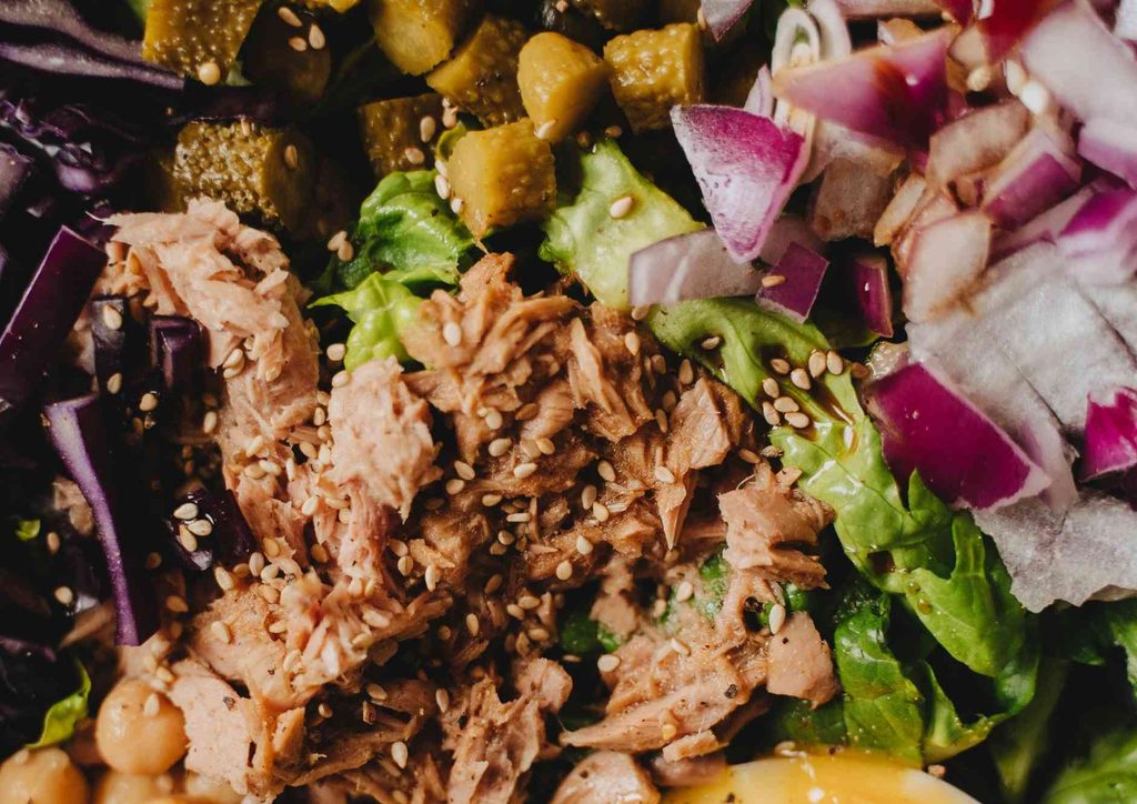 Healthy Dinners for Weight Loss: Easy Weeknight Ideas 13 A detailed view of a salad containing various vegetables, slices of meat, and pickles, showcasing vibrant colours and textures.