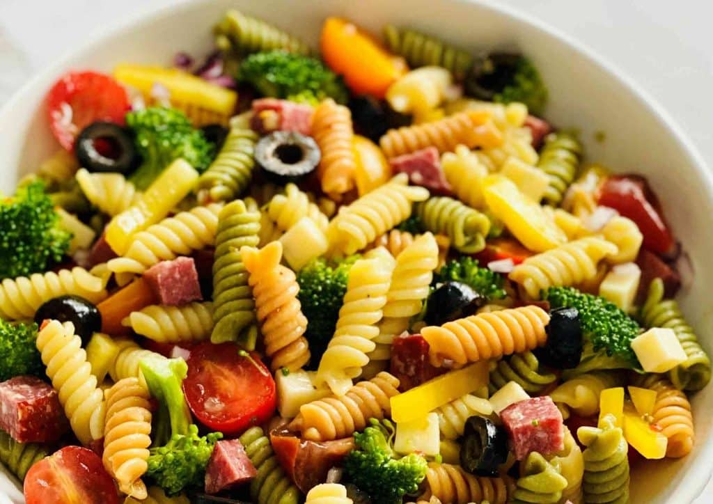 Healthy Dinners for Weight Loss: Easy Weeknight Ideas 18 A delicious pasta salad composed of ham, broccoli florets, and olives, served in a bowl, highlighting a healthy meal option.