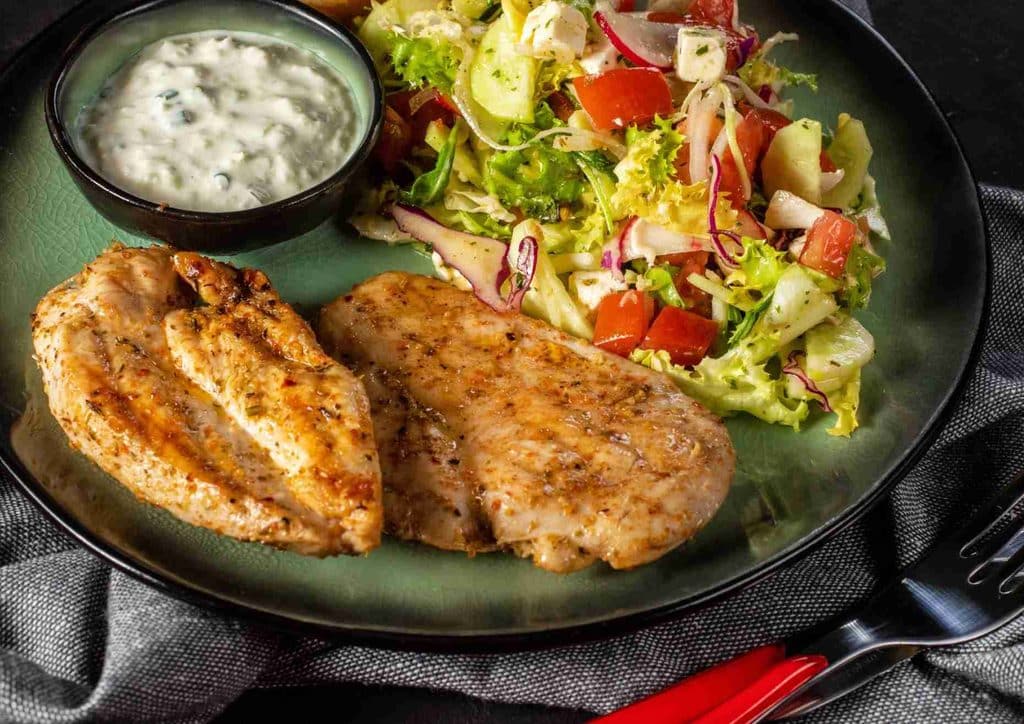 Healthy Lunches for Weight Loss: Work and Home Ideas 36 Grilled chicken breast served with a fresh salad and a side of ranch dressing.