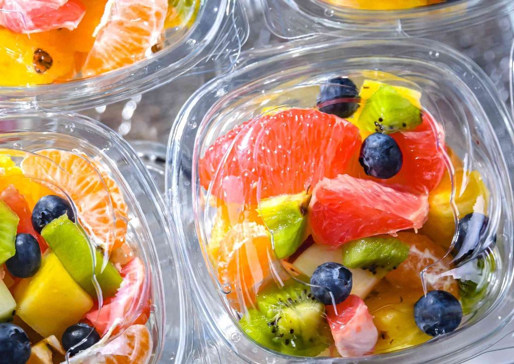 Easy Meals for Weight Loss When You're Short on Time 40 Close-up of assorted fruits displayed in clear plastic containers, showcasing vibrant colours and textures.