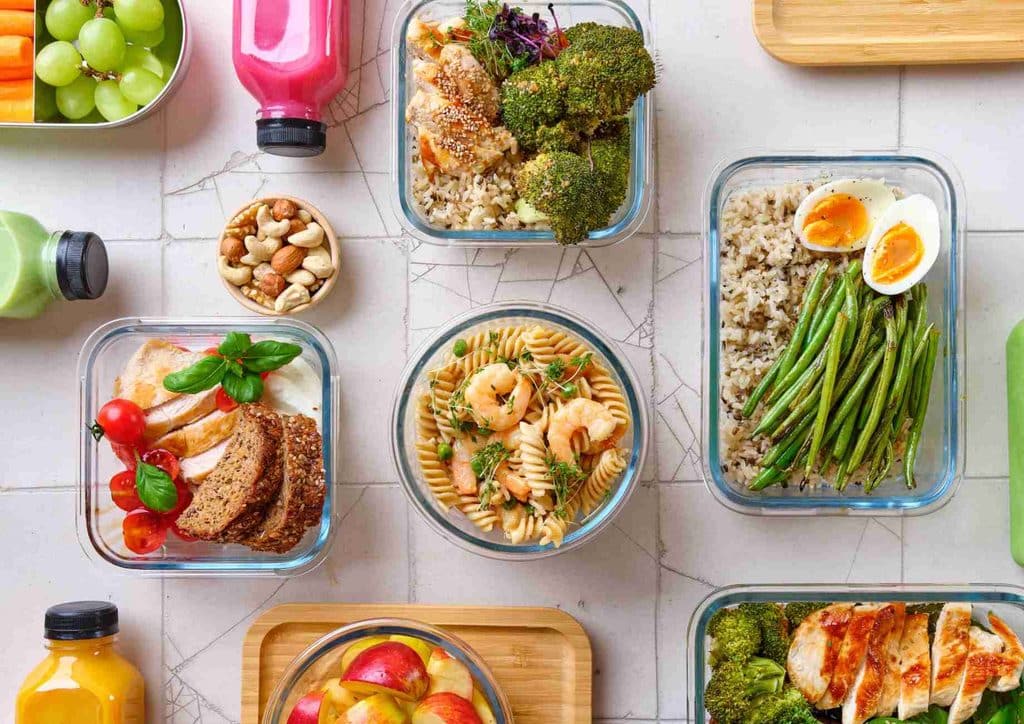 Healthy Meal Plans for Weight Loss: How to Build One That Lasts 22 A selection of healthy foods in clear plastic containers, including fruits, vegetables, and grains, arranged neatly.