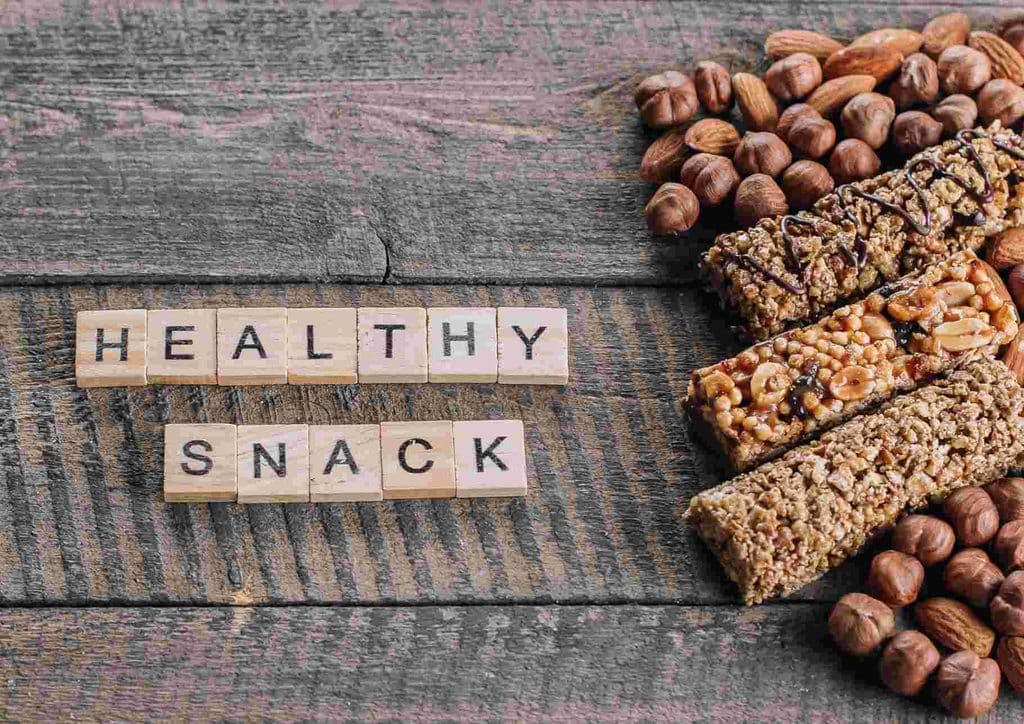 Healthy Snacks for Weight Loss That Actually Keep You Full 16 A variety of nuts displayed on a wooden table, showcasing a healthy snack option.