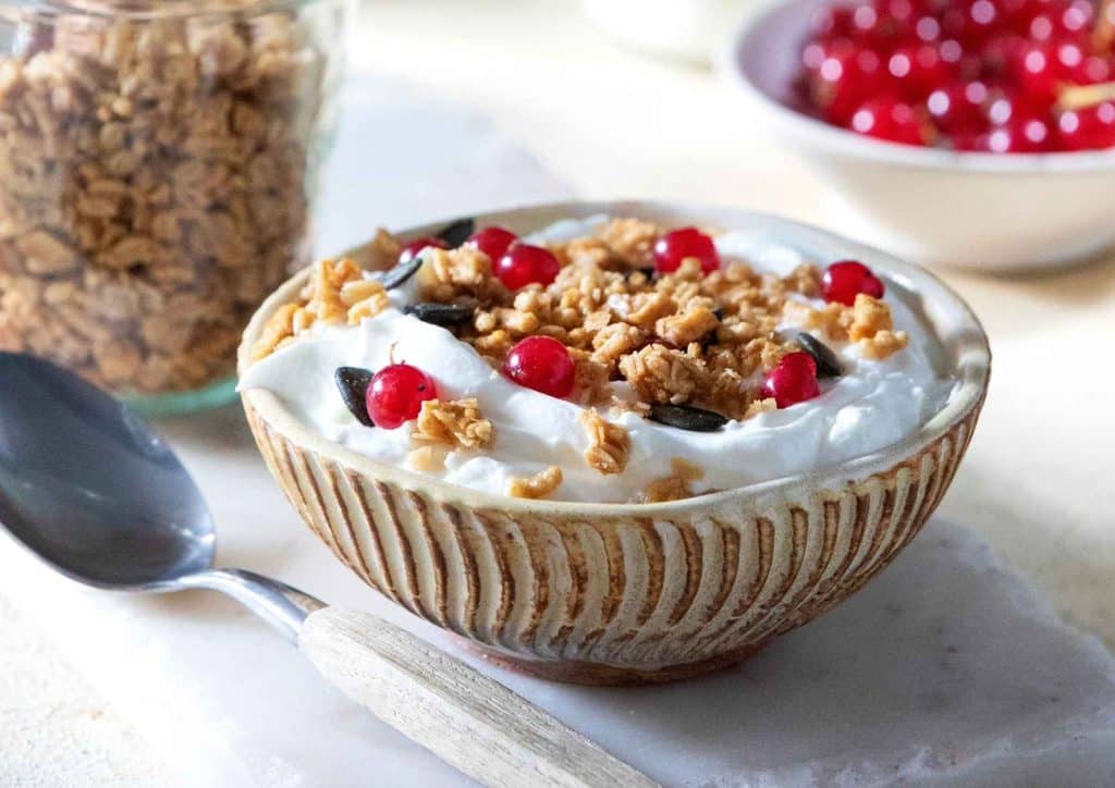 High Fibre Diet for Weight Loss: Why Fibre Keeps You Full 48 A bowl of granola topped with creamy yoghurt and fresh cherries, showcasing a healthy breakfast option.