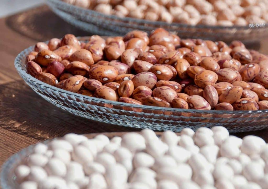 High Fibre Diet for Weight Loss: Why Fibre Keeps You Full 44 A table displaying bowls filled with peanuts, showcasing various sizes and textures of the nuts.
