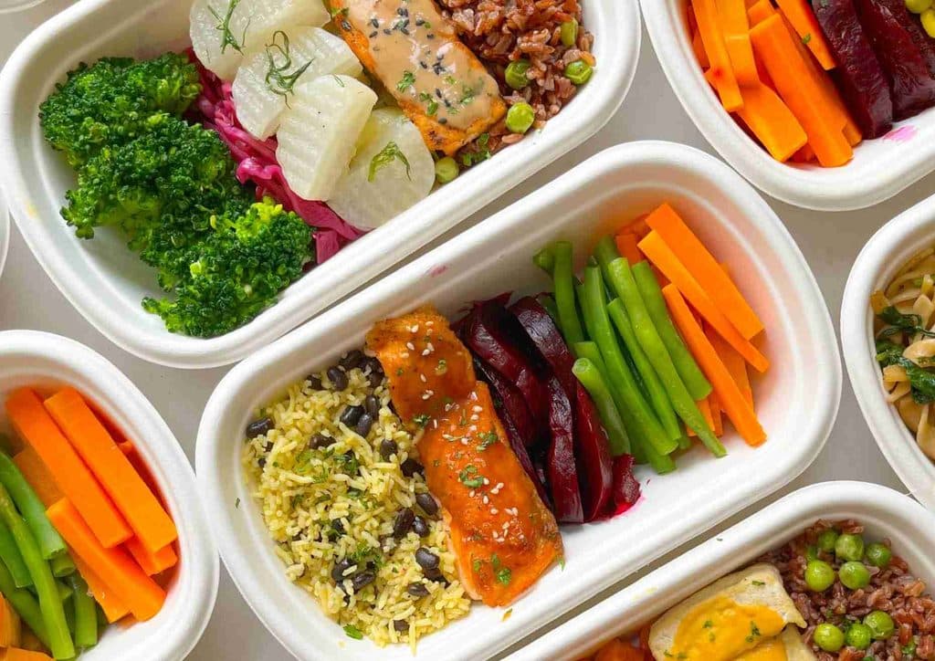Healthy Lunches for Weight Loss: Work and Home Ideas 25 A selection of diverse foods arranged in clear plastic containers, showcasing various colours and textures.