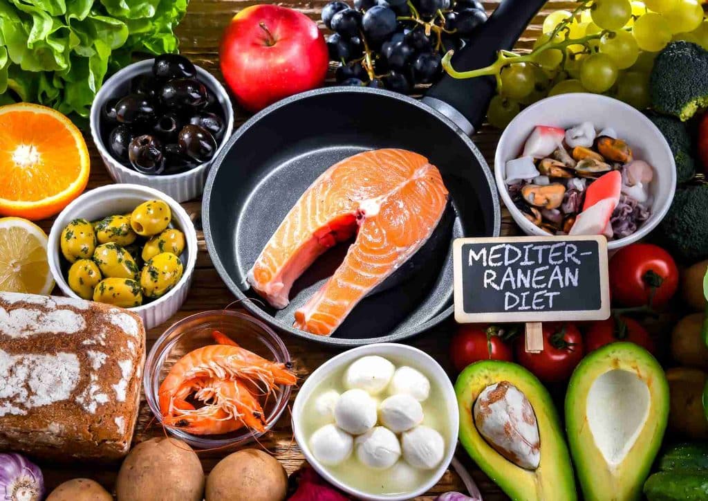 Is the Mediterranean Diet Good for Weight Loss? 1 A diverse selection of nutritious foods, including fish, vibrant vegetables, and ripe fruits displayed together.